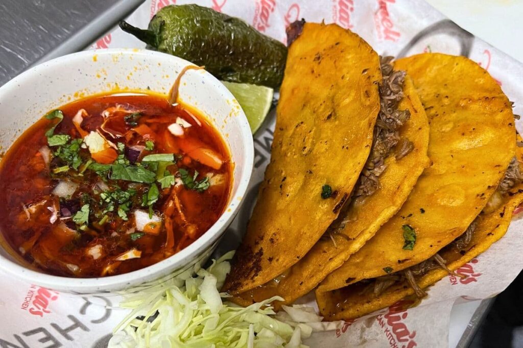 Amelia's Birria tacos served with a cup of consomme