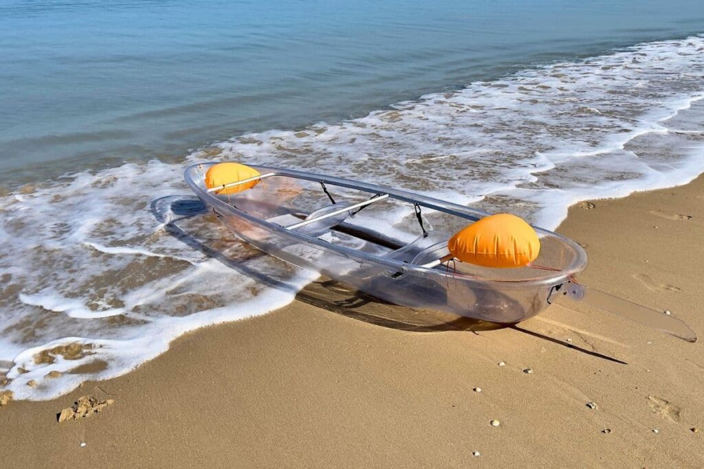 Clear kayak on the beach ready to go in the water