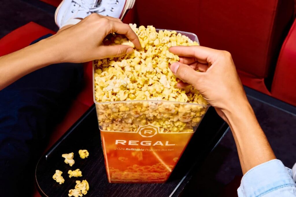 Enjoying Regal Gilbert Theatres popcorn bucket while watching a movie