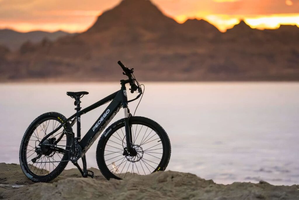 Pedego Ridge Rider Electric Mountain Bike on the sand at sunset