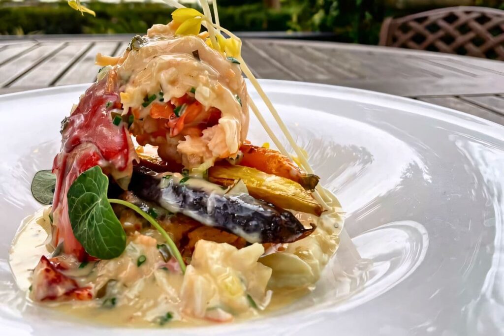 Maine Lobster Trio dish with lobster tail, lobster cake, and lobster butter