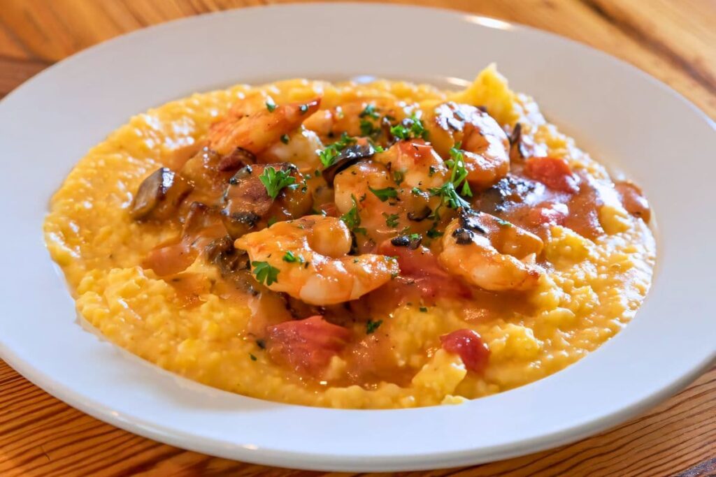 Shrimp and Grits with tasso ham, mushrooms, and tomatoes