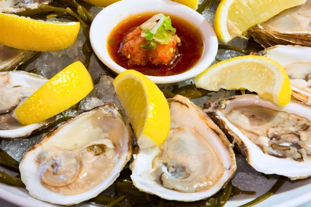 Platter of Oysters with lemon wedges